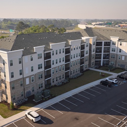 an aerial view of a building near a highway