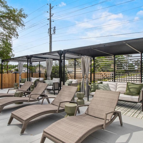 a patio with chairs and umbrellas